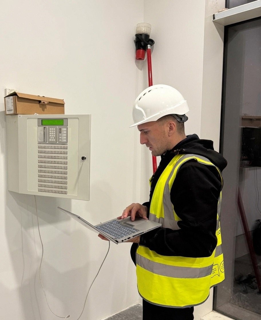 A Vanguard engineer commissioning a fire alarm control panel